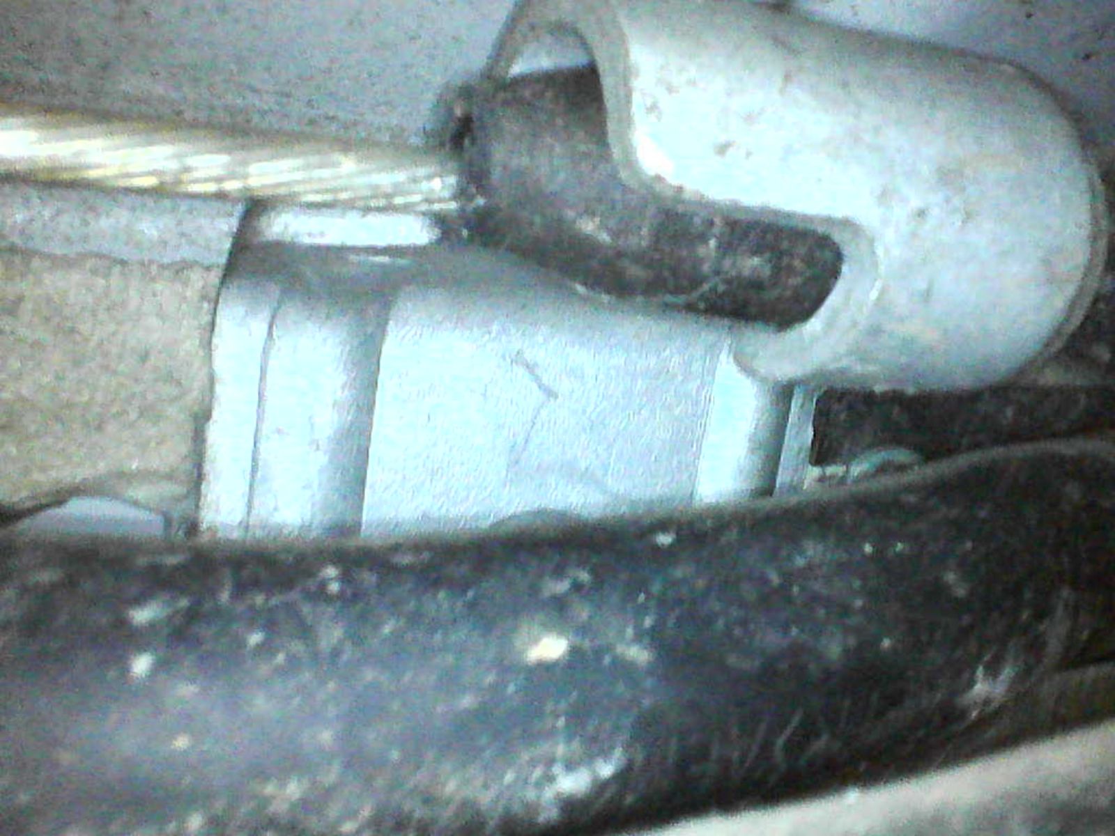 Handbrake cable bracket behind heat shield offside 2.jpg